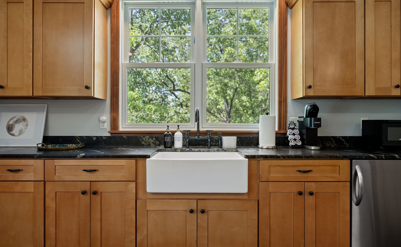 There's something so comforting about a kitchen with wooden cabinets and a timeless sink.
