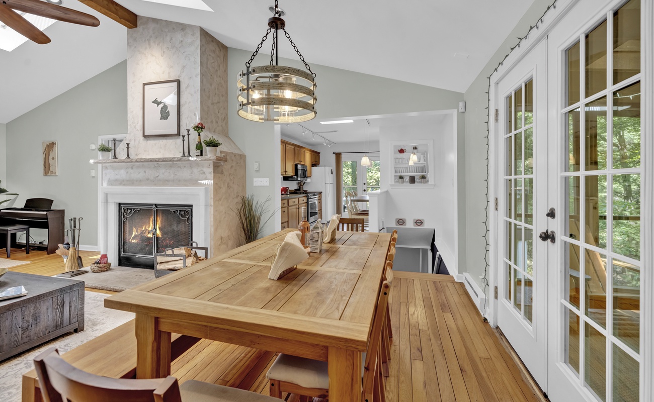 Elegant dining meets glowing hearth and open kitchen.