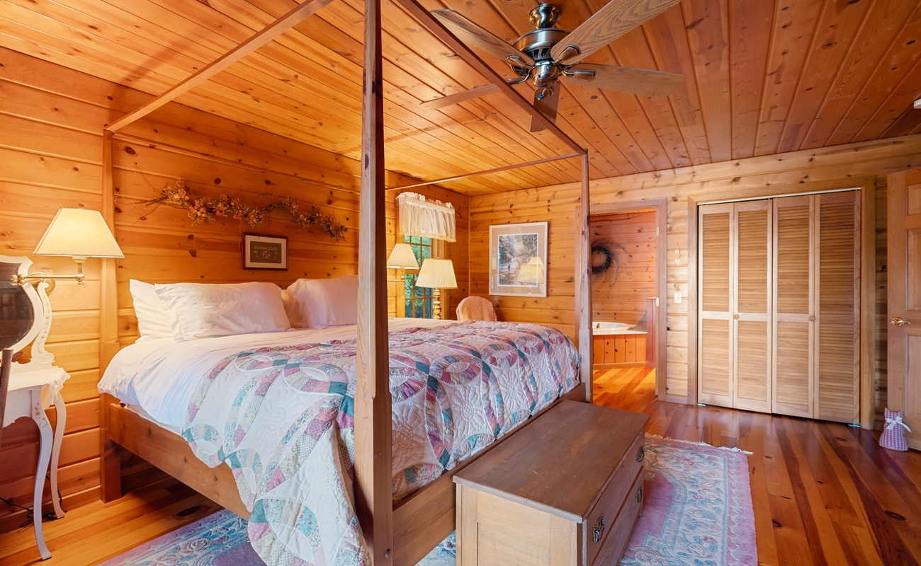 The primary bedroom offers a luxurious escape with its rustic design and ensuite bathroom.