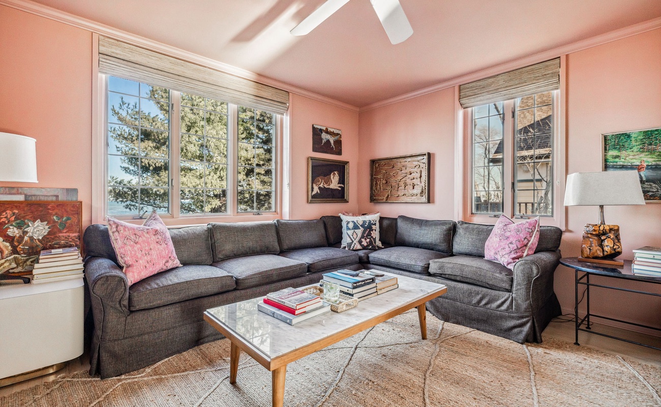 Blush walls, soft lighting, and a sectional that says ‘stay a while.’ How can you resist?