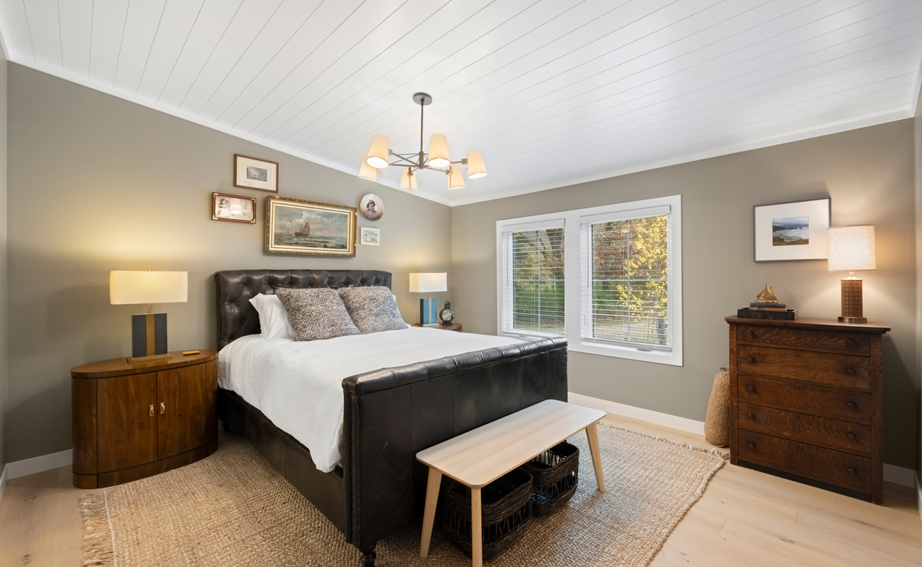 Spacious main bedroom with private bath and natural light.