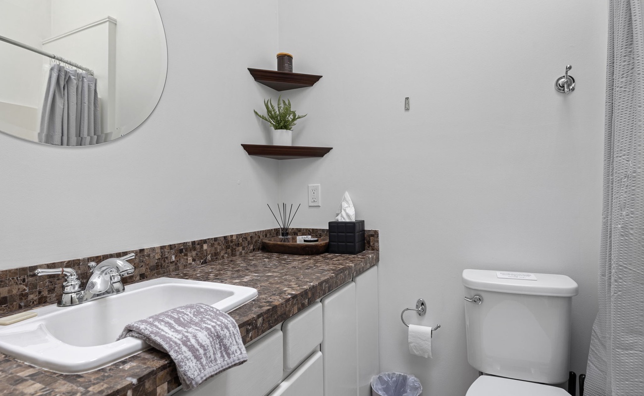 The Master Bathroom is smartly designed with a wide, beautifully tiled vanity.