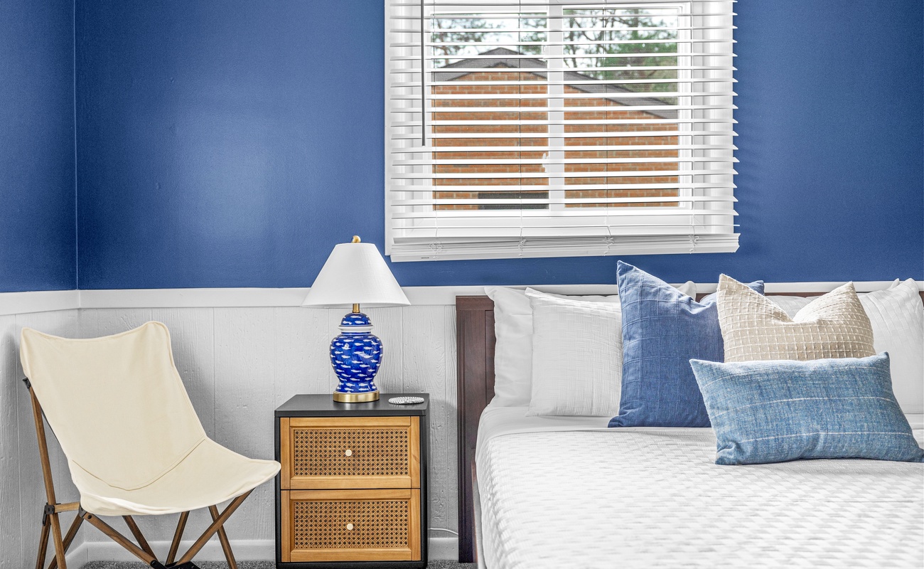 Pop of blue, tailored vibes, and natural light. This bedroom is all about comfort and charm.