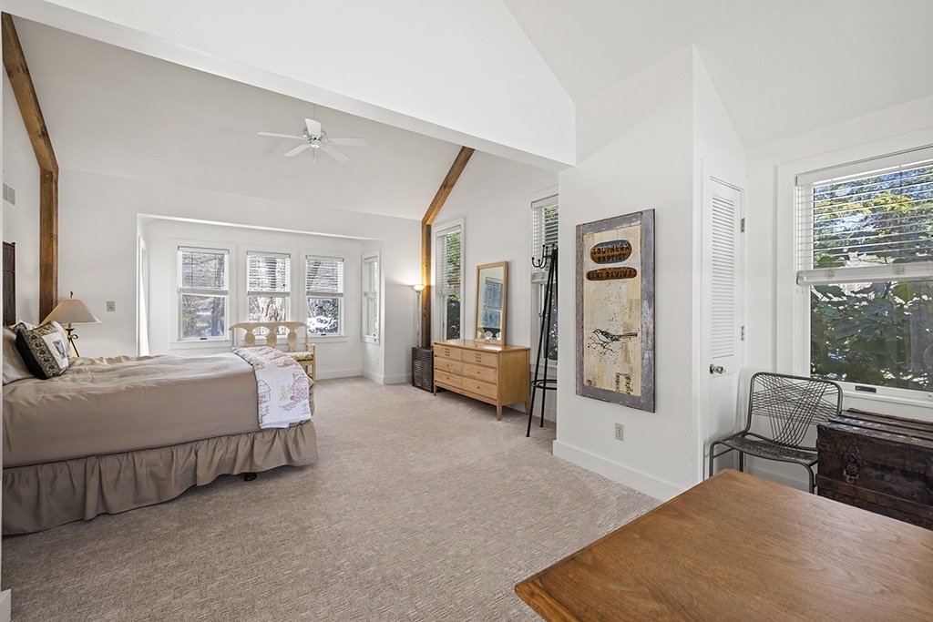 The airy primary bedroom creates a peaceful haven at the heart of The Farmhouse.