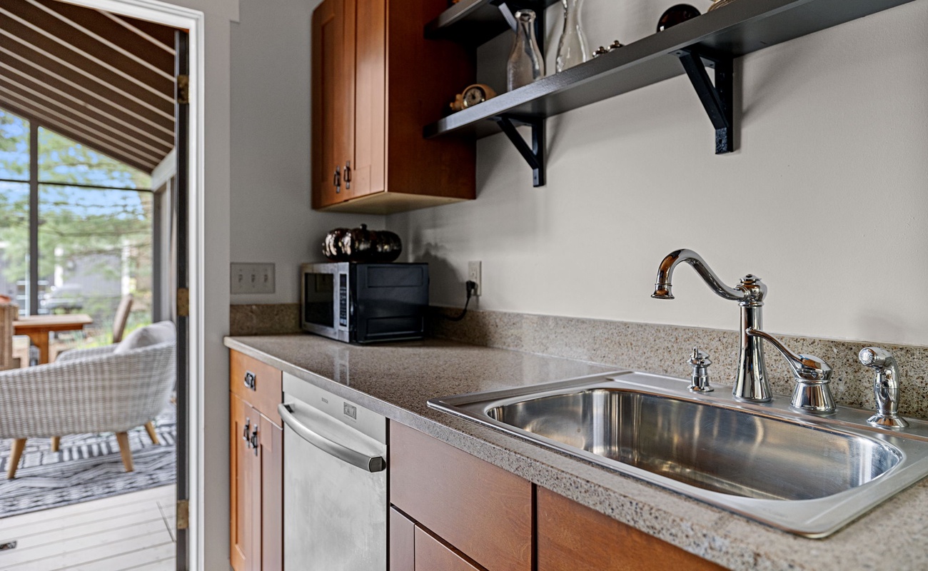 Just off the kitchen is a way-nicely furnished 3-Season porch and dining table.