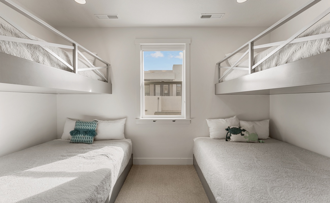 Sleep soundly in these custom built-in bunks, perfect for kids or groups seeking cozy, space-efficient comfort.