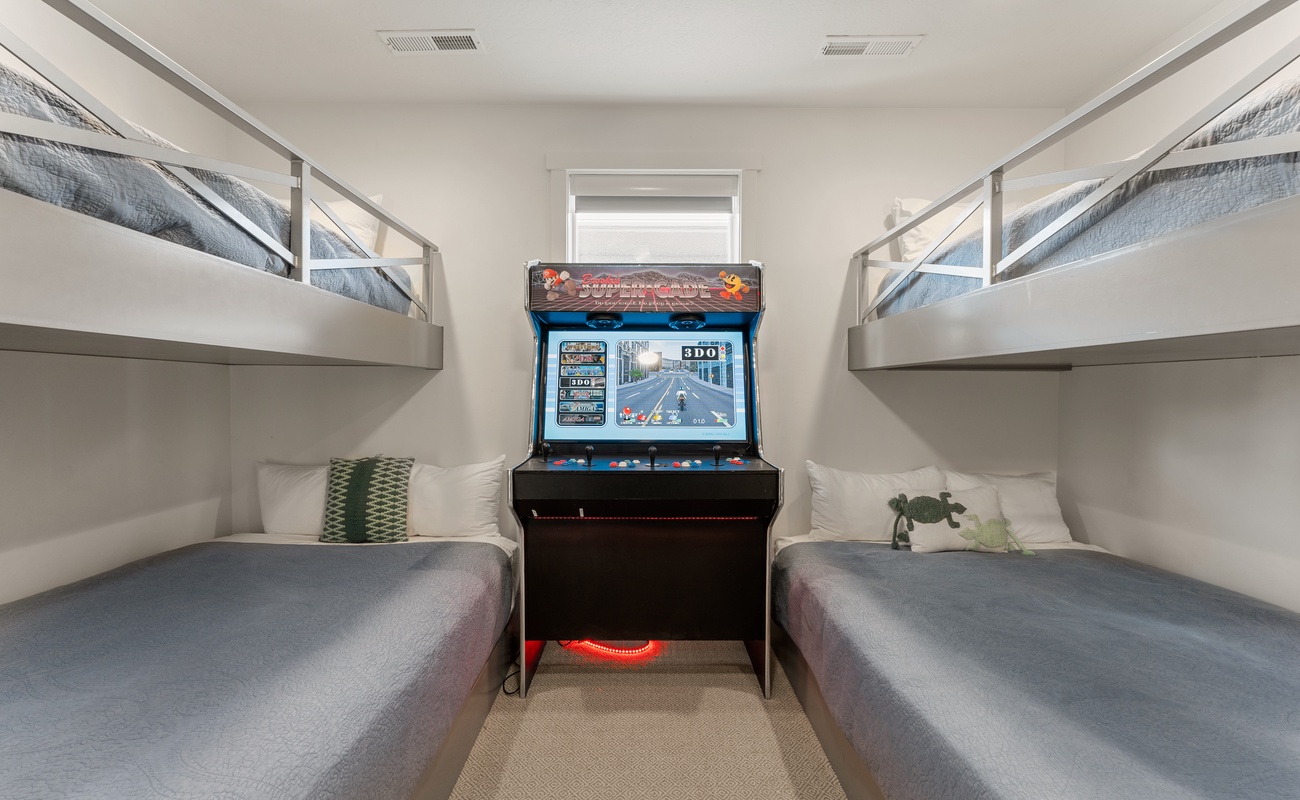 Your kids will love this fun bunk room with a classic arcade game right between the beds for endless entertainment.