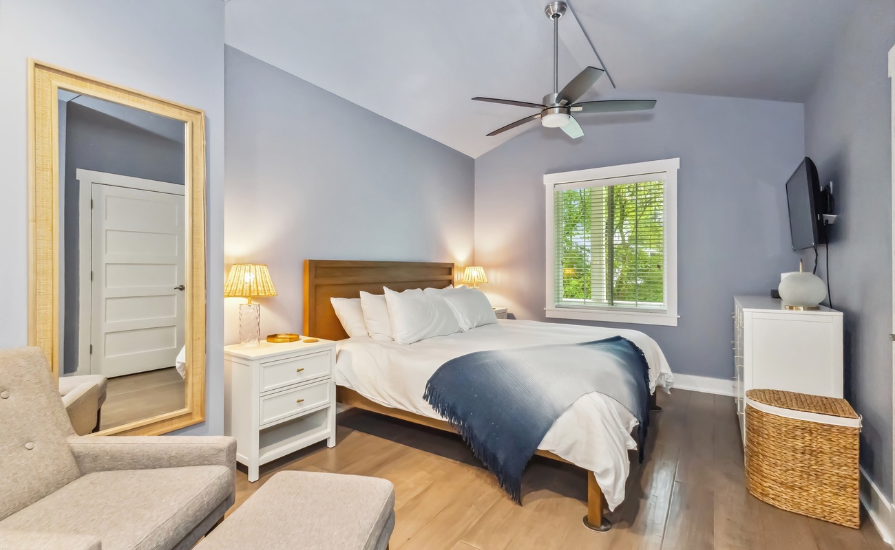 The primary bedroom is bright and airy with a King bed