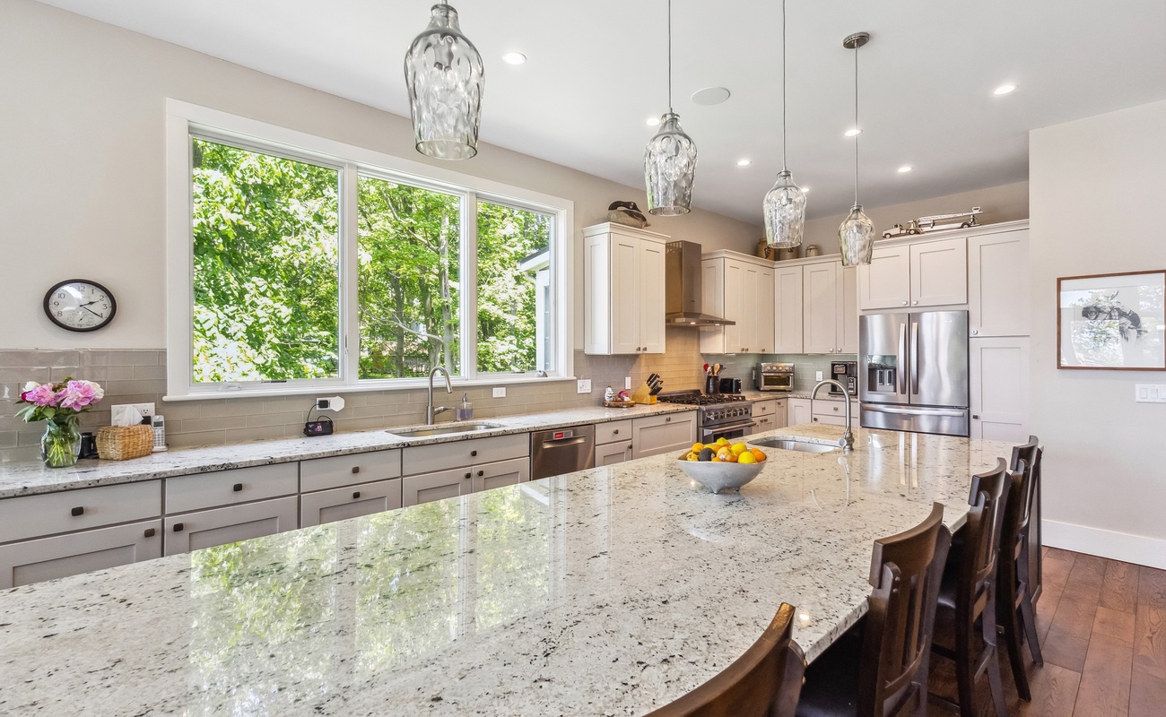 Stylish kitchen featuring a large island for prep and dining.