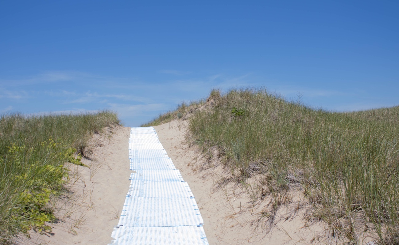Walk to the beach from the back of the home