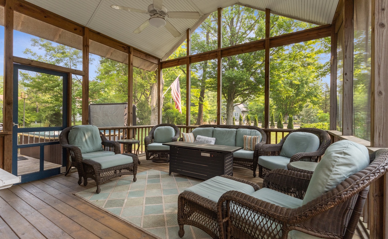 Cozy screen porch with TV and fire table