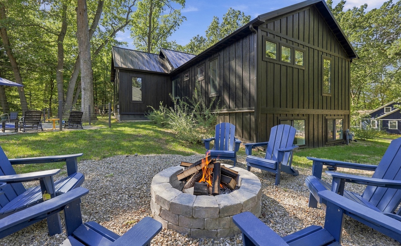 Backyard Fire Pit with Adirondack Seating in a Wooded Setting