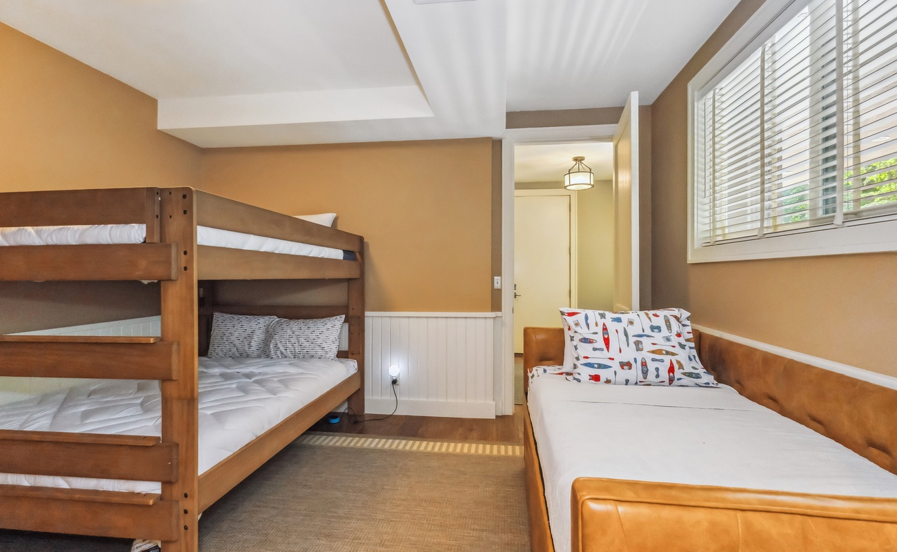 A Queen-over-Queen bunk and Twin with trundle make this the ultimate sleepover suite