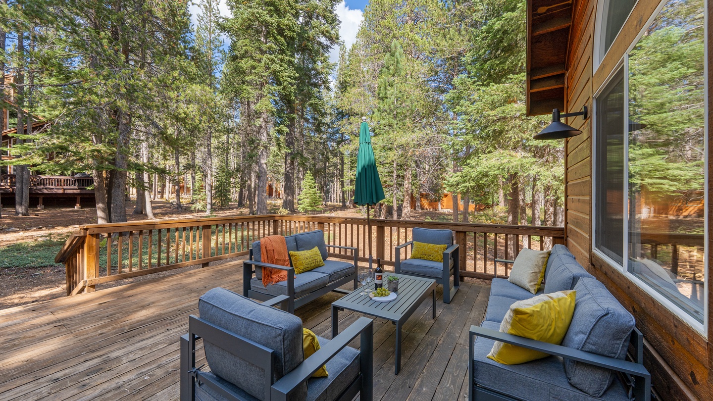 Settle into your private deck surrounded by towering pines, where morning coffee and evening wine feel like moments made just for you.