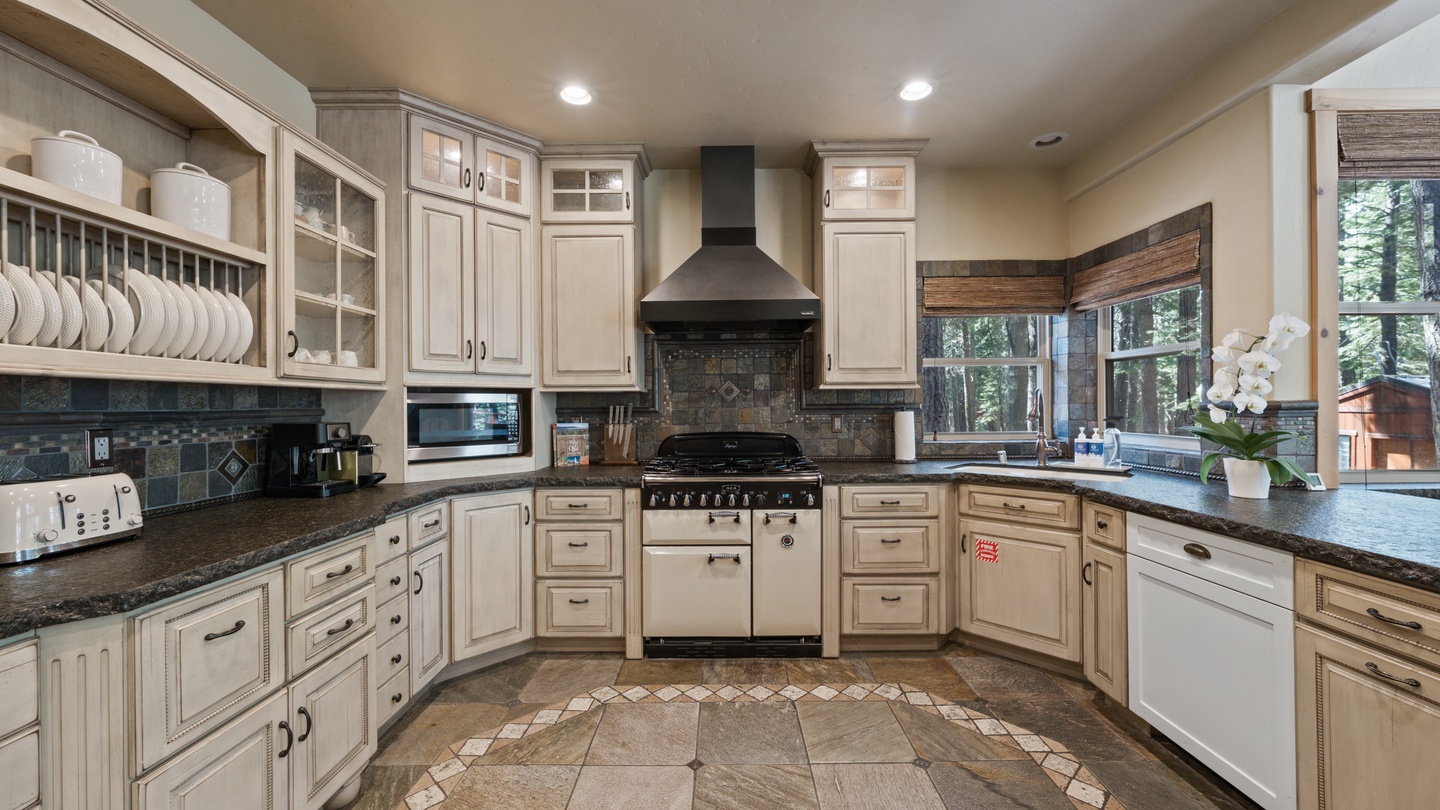 Prepare delicious meals in this fully-equipped kitchen with its generous counter space, professional-grade appliances, and abundant cabinetry. Natural light streams in through windows overlooking the peaceful forest surroundings.