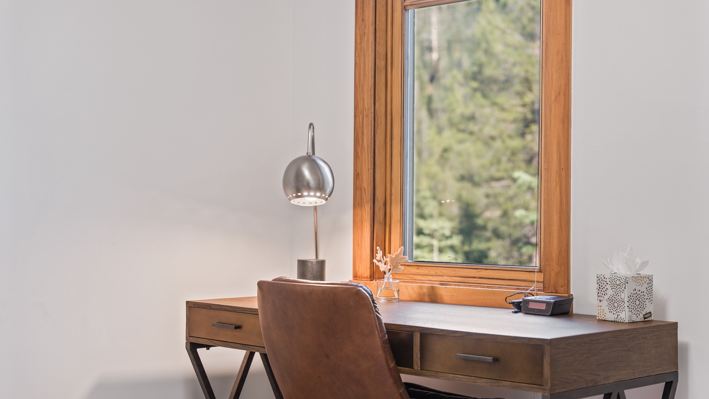 Your own quiet workspace with natural light streaming through the window and peaceful views of the surrounding greenery—perfect for catching up on emails or simply enjoying morning coffee.