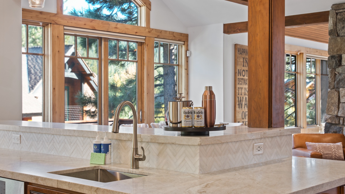 Gather around your spacious kitchen with gleaming countertops, warm wood beams overhead, and abundant natural light streaming through large windows. Your mountain retreat's heart invites you to create memorable meals together.