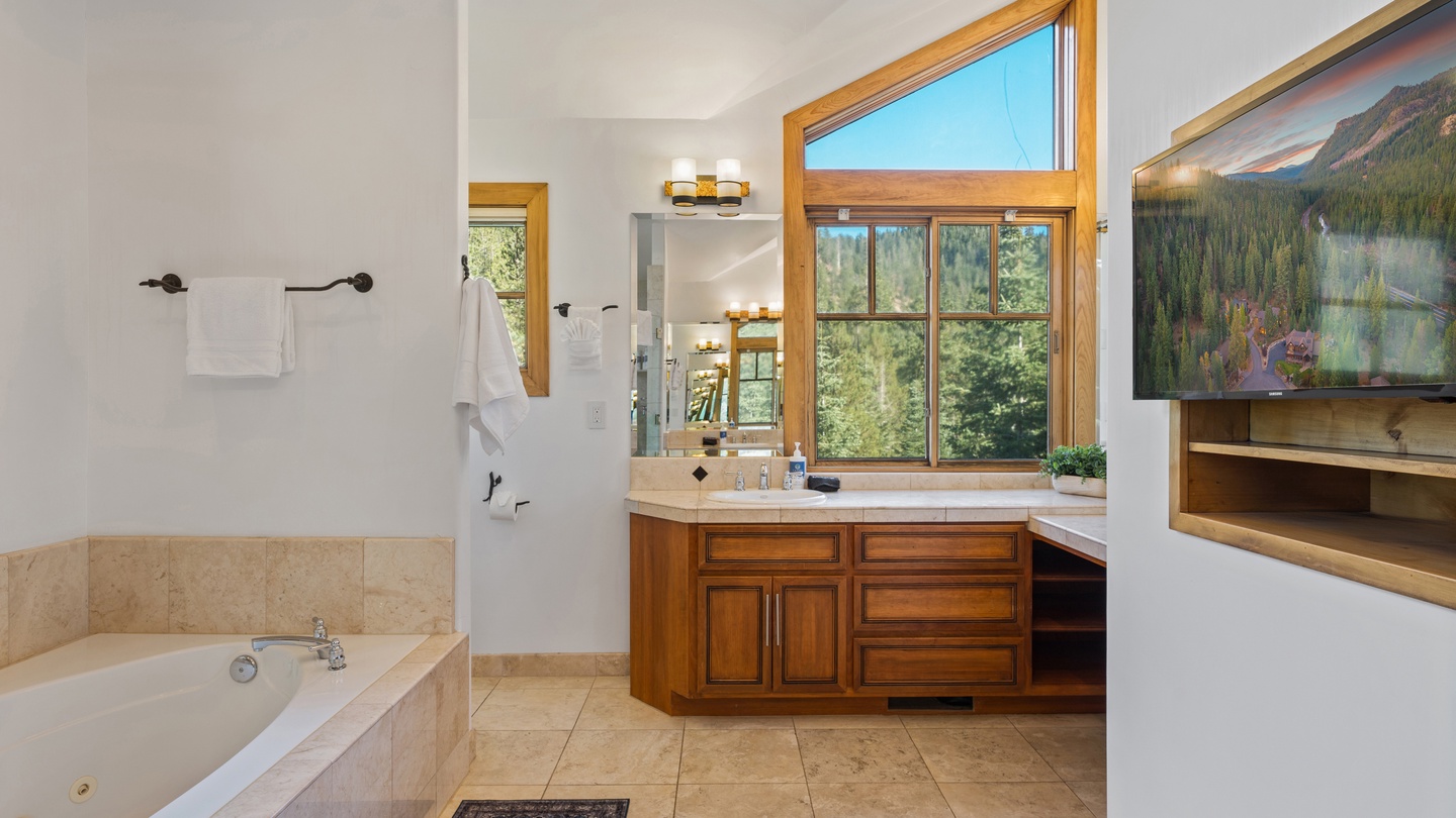 Unwind in your private spa-like bathroom with a soaking tub and views of the surrounding greenery through transom windows. Fluffy towels await after you relax.