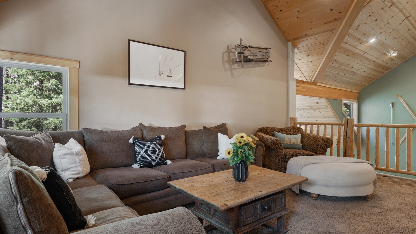 Sink into plush seating beneath soaring wood-beam ceilings as natural light streams through your windows, creating the perfect retreat for relaxing with loved ones.