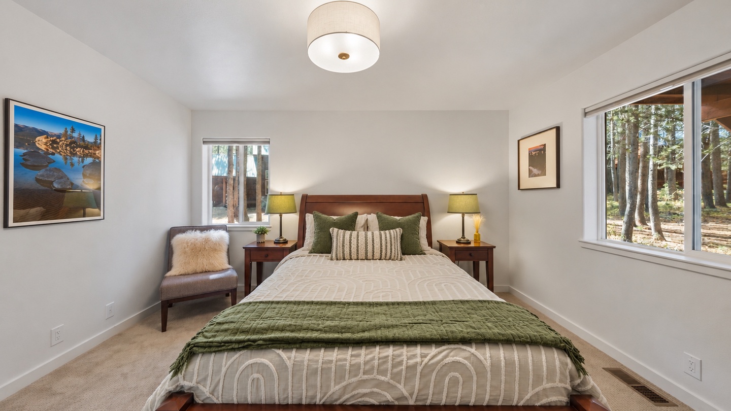 Sink into soft linens and wake to sunlight filtering through tall pines just outside your window. This peaceful bedroom features warm wood tones and thoughtful touches for a restful night's sleep.