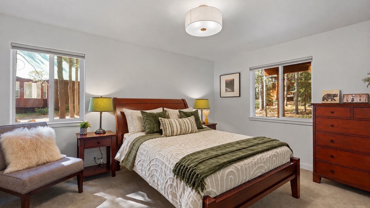 Sunlight streams through the windows, casting a gentle glow across your inviting bedroom retreat. Wake up to views of tall trees and relax into the comfort of plush bedding.