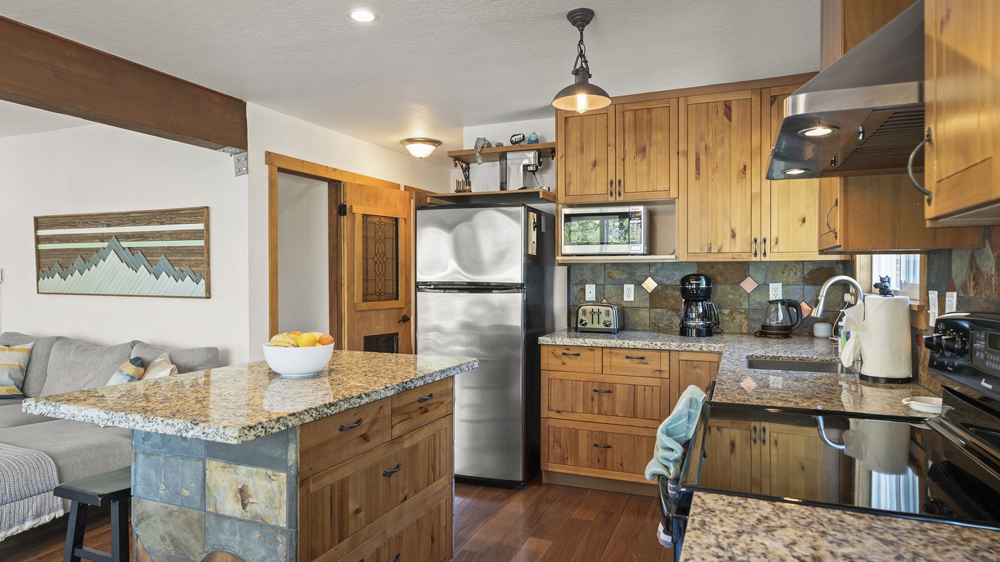 You'll love cooking in this fully-equipped kitchen with granite counters, stainless appliances, and a breakfast bar perfect for morning coffee.