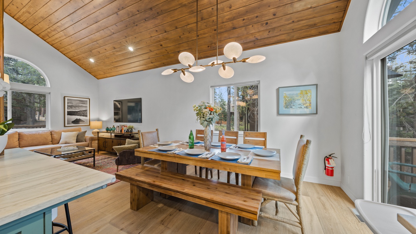 Gather around the handcrafted dining table with your favorite people while natural light pours in through the vaulted ceiling, creating the perfect setting for shared meals and lasting memories.