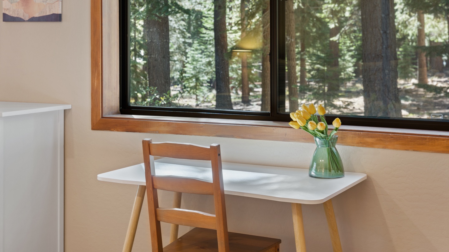 Set up your workspace at this desk with forest views, where tall pines create your inspiring natural backdrop.