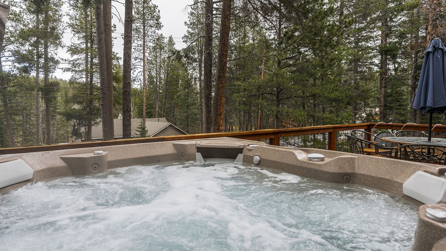 Soak in your private hot tub surrounded by towering pines, where bubbling jets melt away stress amid nature's tranquil embrace.