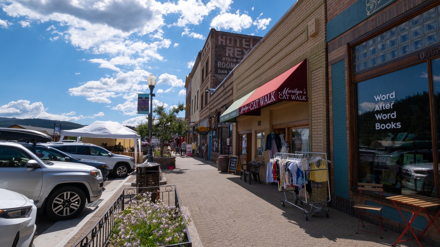 Charming downtown street with local shops, cafes, and mountain views creating an authentic small-town atmosphere for exploring.