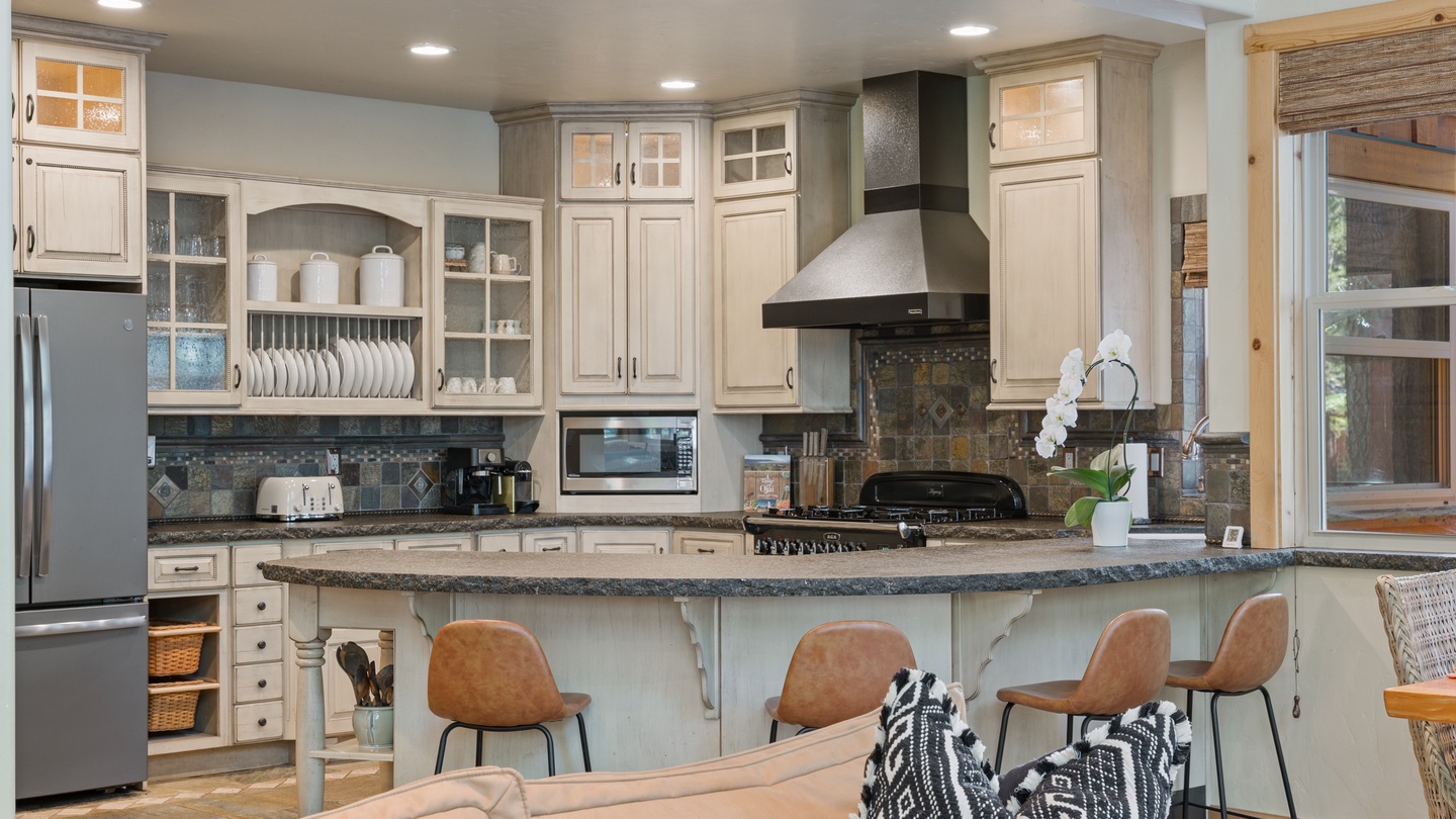 Step into this bright, open kitchen where you'll find everything you need to prepare meals together. The large island invites gathering, and the fully equipped space makes cooking feel effortless and enjoyable.