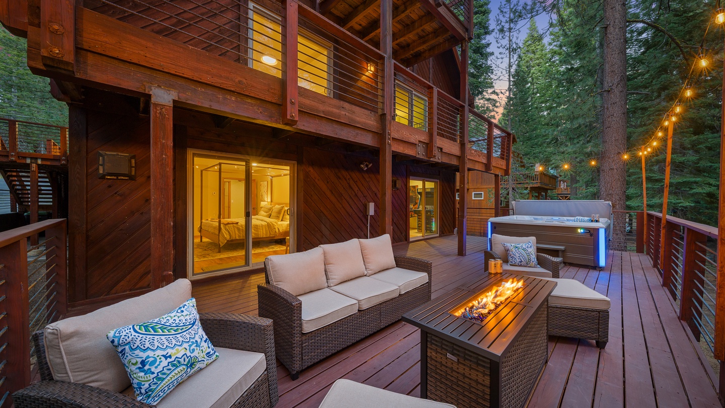 Nestled among towering pines, this beautifully crafted multi-level retreat invites you to unwind on the expansive deck with a crackling fire pit, plush seating, and your own private hot tub under the stars.