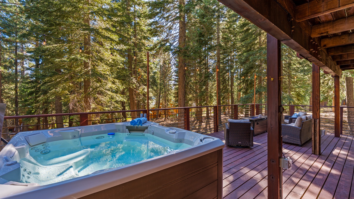 Unwind in your private hot tub on the deck, surrounded by towering pines and peaceful forest views—your perfect mountain retreat awaits.
