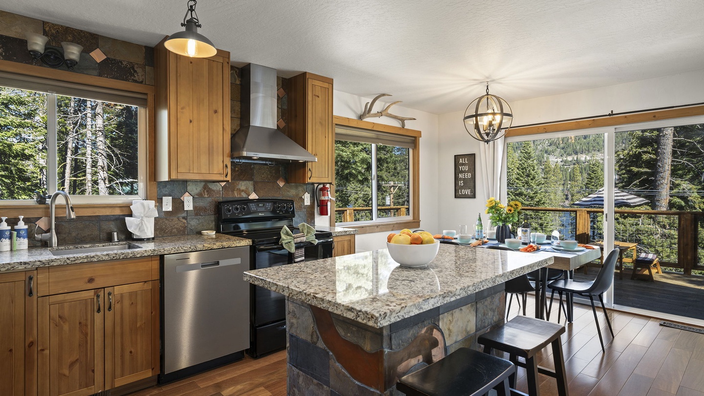 Your spacious mountain kitchen offers granite counters, stainless appliances, and forest views while you cook and dine together.