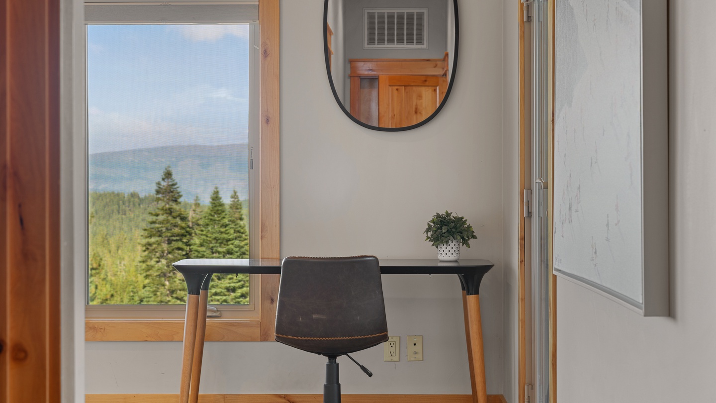 Your personal workspace overlooks tranquil waters and forested shores, offering a peaceful backdrop for work or planning your next adventure.