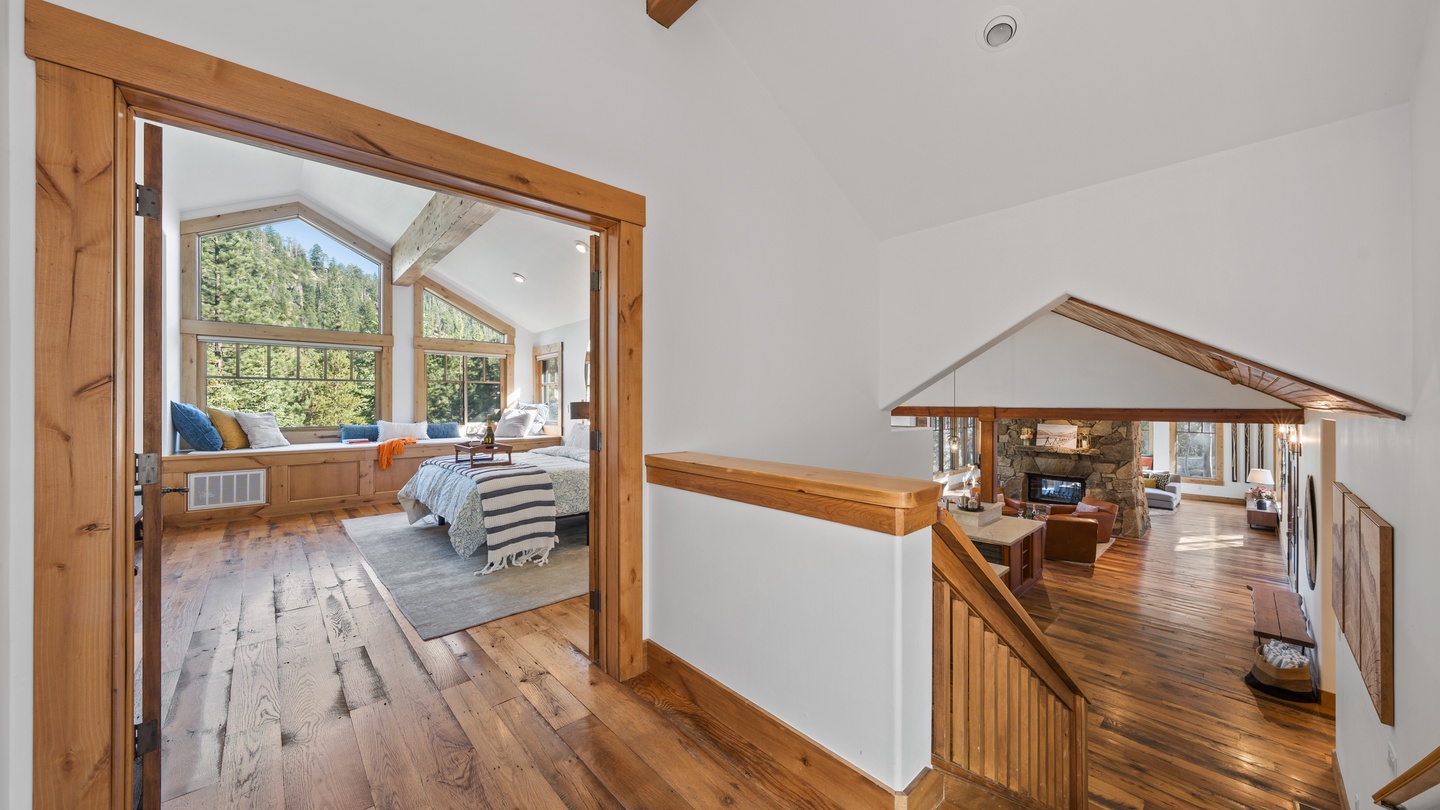 Warm wood accents and soaring ceilings welcome you to a space that feels both expansive and inviting, with mountain views framing your getaway in natural beauty.