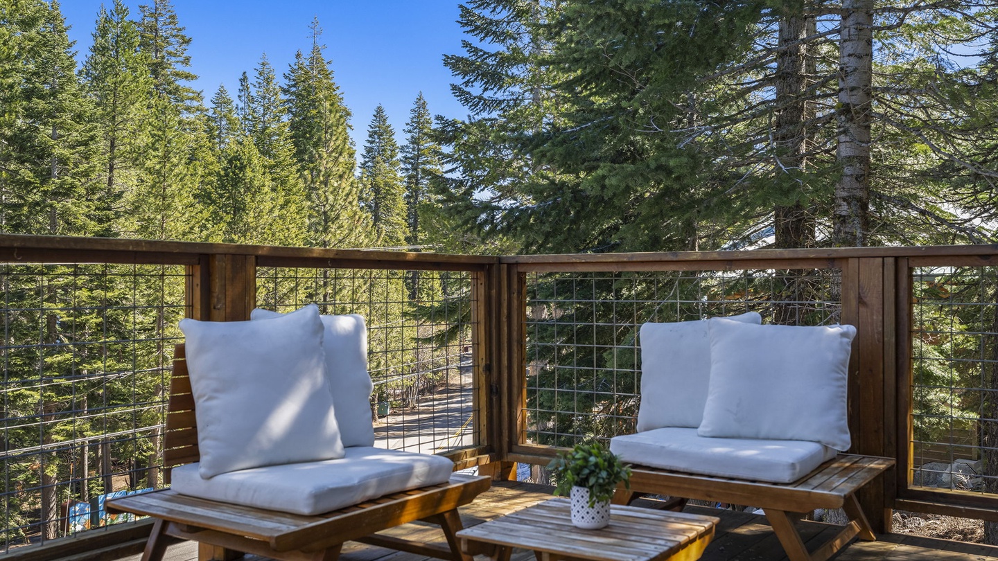 Relax on this stunning treetop deck with comfortable seating and breathtaking forest views stretching endlessly before you.