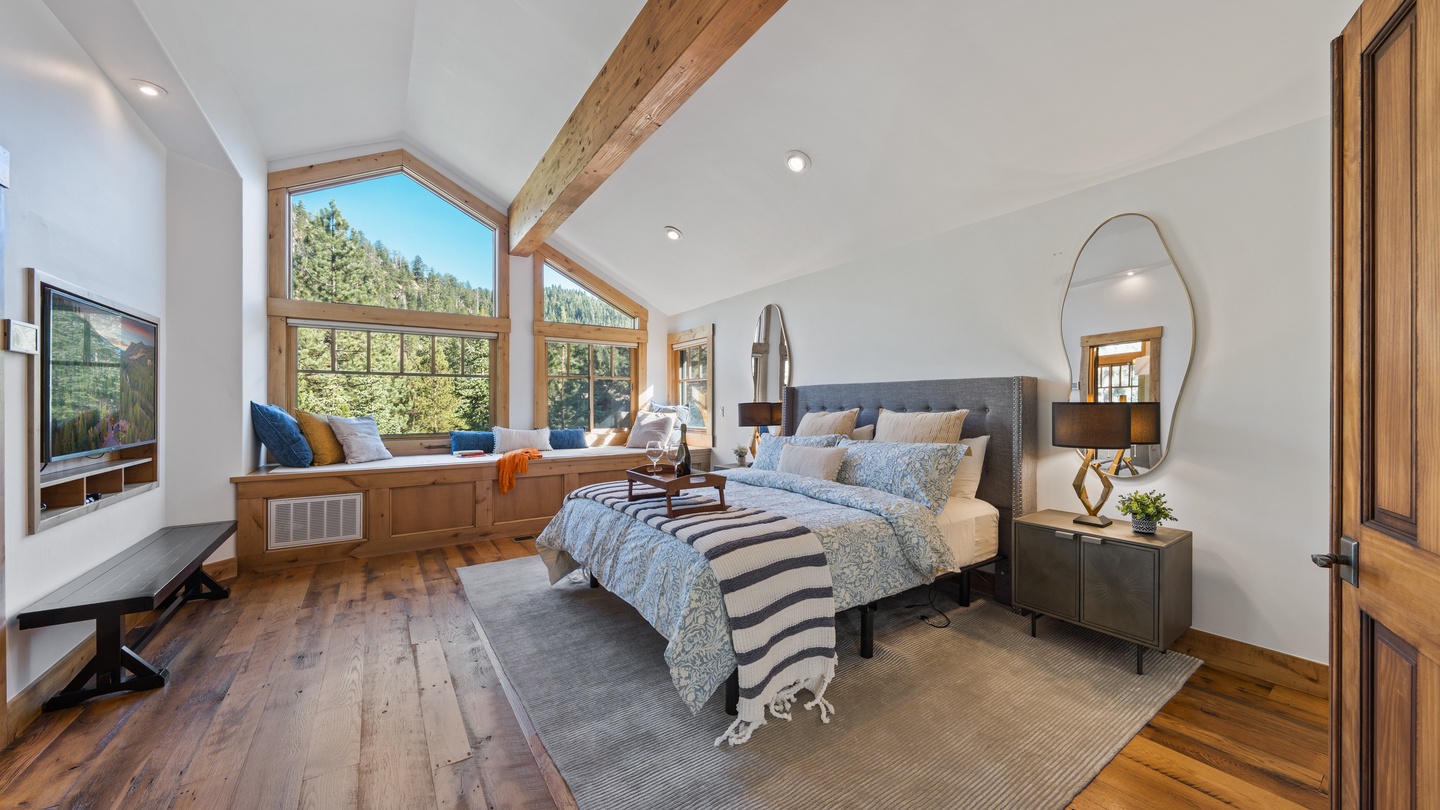 Sunlight pours through vaulted windows overlooking the forest, warming the exposed beam ceiling and hardwood floors. Sink into your plush bed and let the natural beauty outside ease you into mountain serenity.