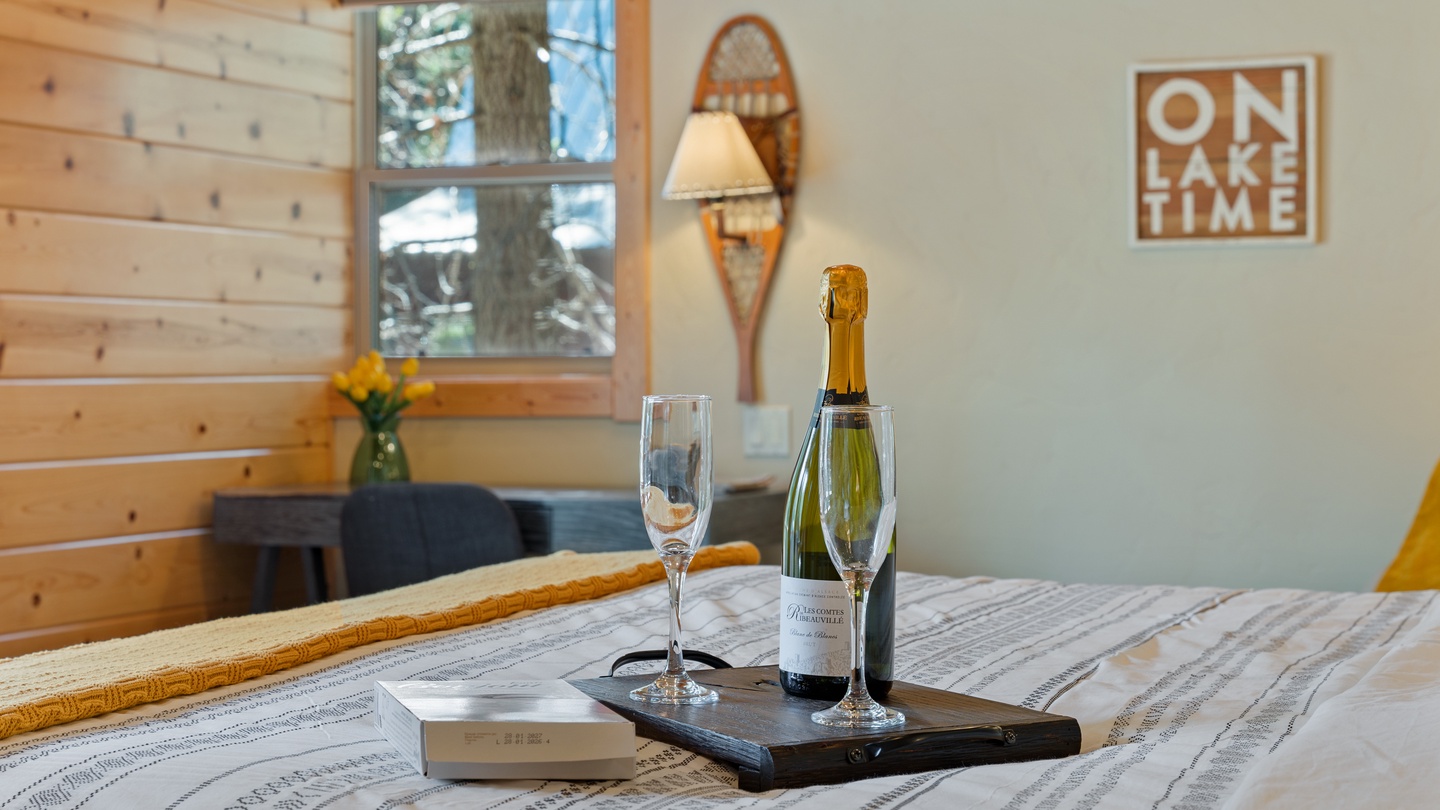 Unwind with a celebratory glass of bubbly in your cozy retreat. Warm wood accents and rustic touches create the perfect backdrop for your lakeside getaway.