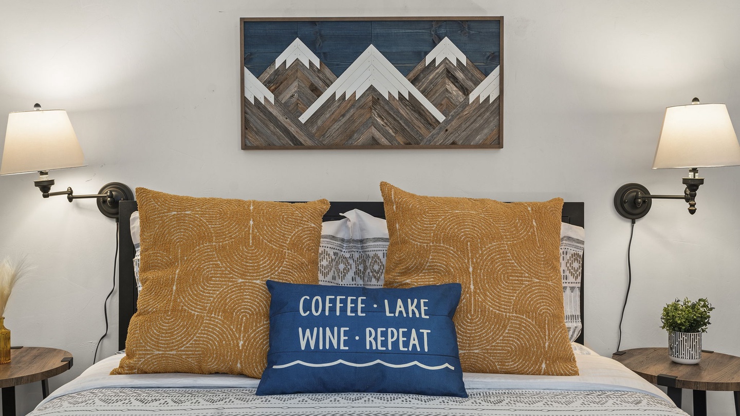 Drift off surrounded by mountain-inspired art and cozy lake vibes in this thoughtfully designed bedroom sanctuary.