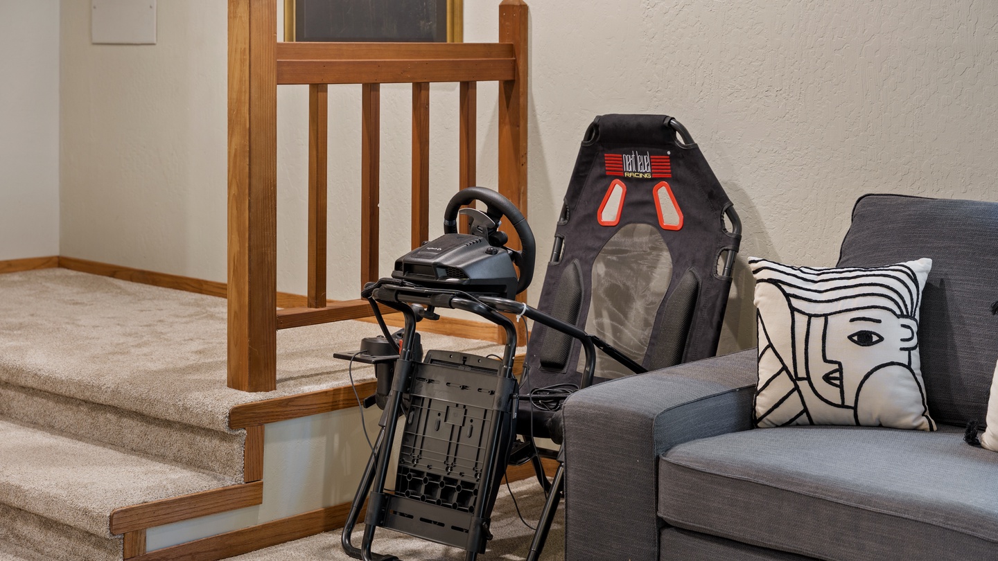 Your game room awaits with a racing simulator setup, complete with steering wheel and seat—perfect for some friendly competition during your stay.