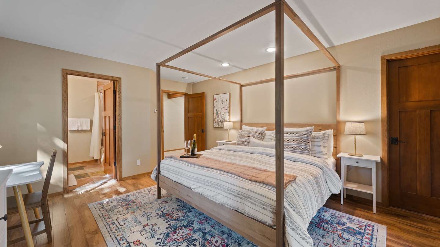 Step into your serene bedroom retreat, where a striking canopy bed frames your restful nights. Warm wood tones and soft lighting create the perfect atmosphere for unwinding after your adventures.