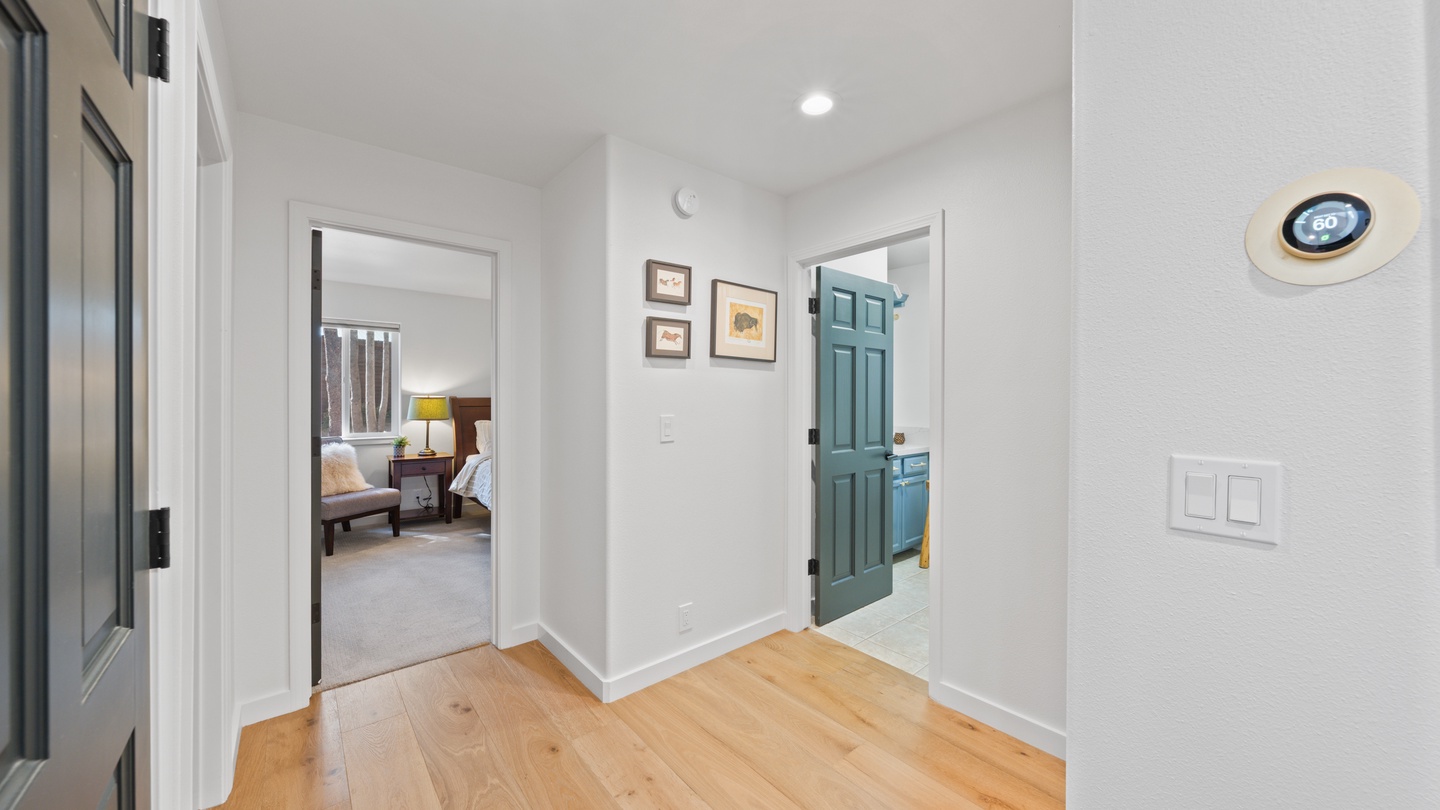 A bright hallway connects your private retreat to the rest of the home, with warm wood floors underfoot and clean modern finishes throughout.