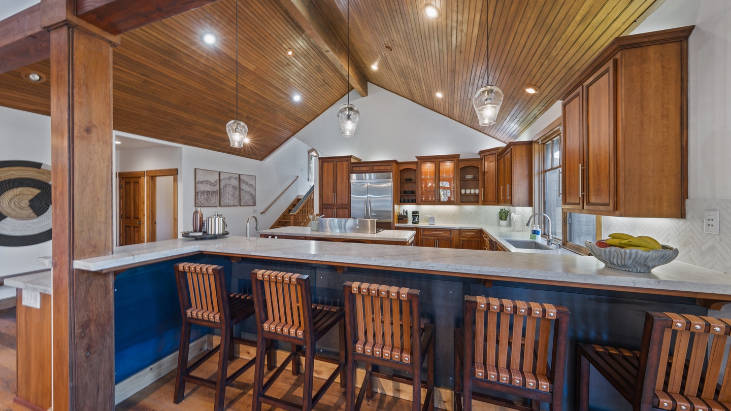 Your gourmet kitchen with soaring wood ceilings, chef-grade appliances, and spacious island invites you to gather and create memorable meals together.