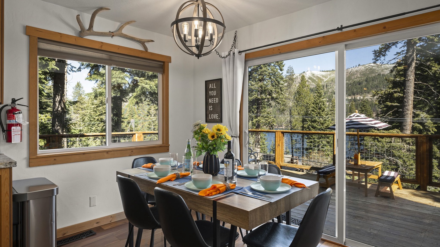 Gather around your beautifully set dining table, where warm wood accents and forest views create the perfect setting for memorable meals together.