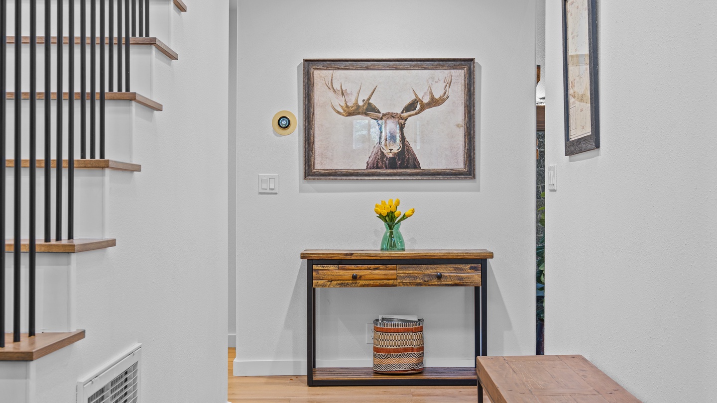 A bright entryway welcomes you with rustic charm, featuring warm wood accents, natural light, and inviting decor that sets the tone for your mountain getaway.