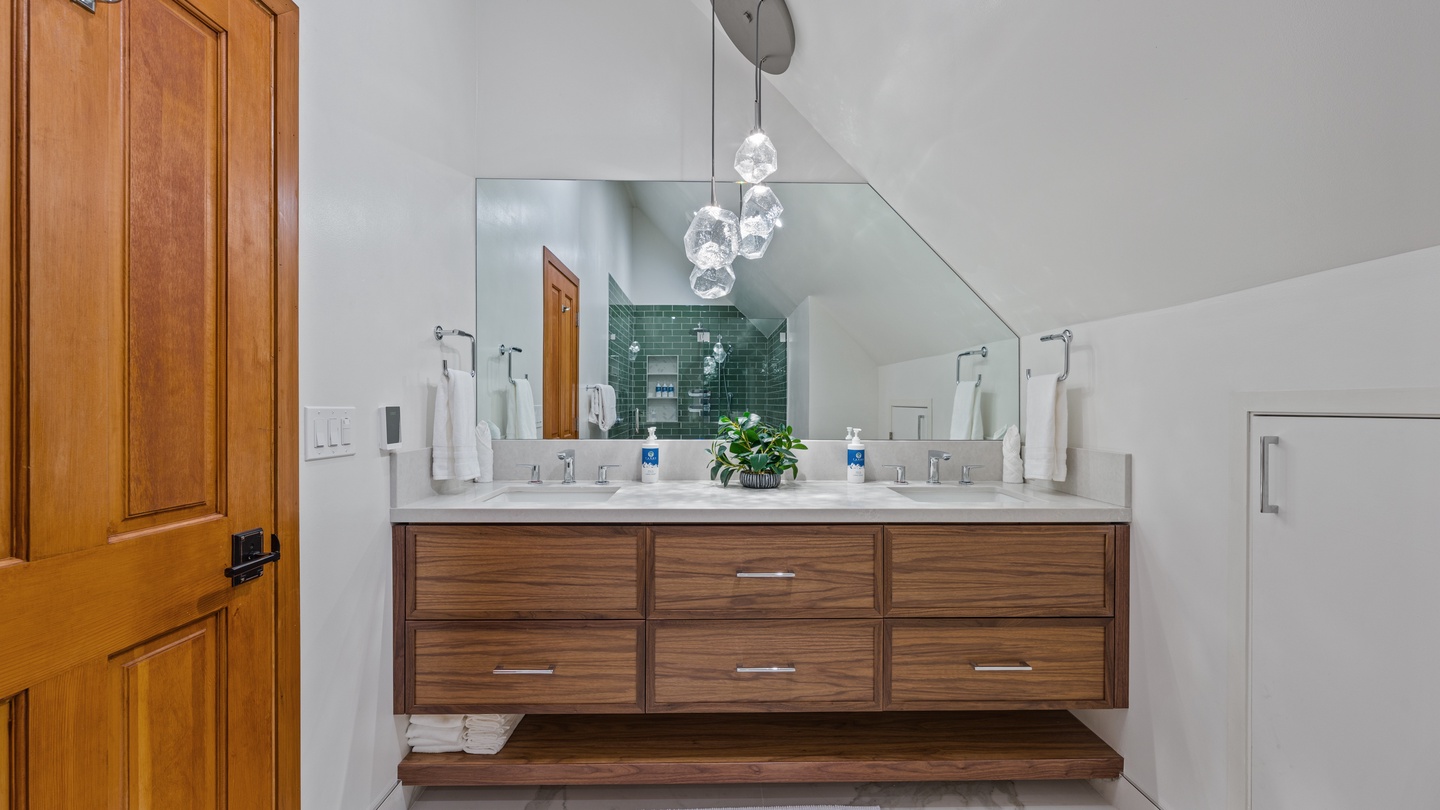 Step into your spa-like ensuite with a sleek double vanity, elegant lighting, and serene tile accents that set the perfect mood for your morning routine.