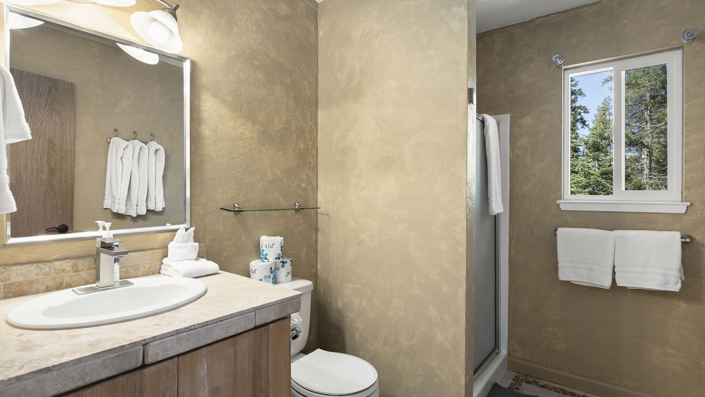 Your private bathroom features modern fixtures and a spacious walk-in shower, creating a peaceful retreat after your adventures.