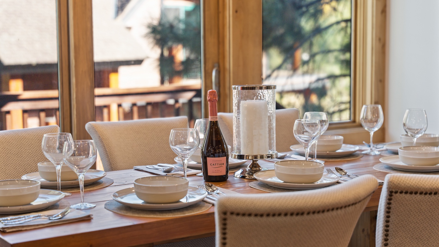 Picture yourself gathered around this beautifully set table, sharing stories and toasting to memorable moments with loved ones as natural light fills the room.