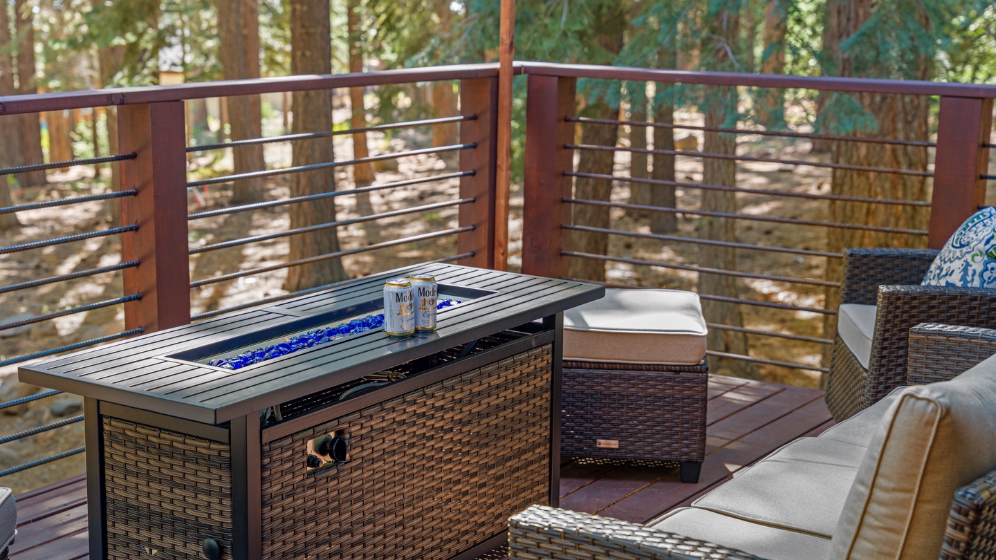 This peaceful deck invites you to unwind surrounded by towering trees, with comfortable seating and a fire feature perfect for evening relaxation in the fresh mountain air.